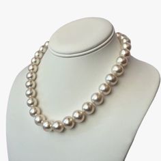 Featuring a high quality White South Sea pearl necklace, this piece secures with a 14K yellow gold interlocking oval clasp. The enticing 100% natural color - a pure white with a gentle hint of pink overtone. Pearls' size ranges from 11.9 to 13.0mm, and are round or near round in shape. You'll be captivated by their high luster. The necklace has a convenient length of 17" (43cm), making it an ideal accessory for any occasion. The surface of the pearls is 85-90% clean, presenting only a few natura Luxury Vintage Round Bead Pearl Necklace, Cheap Vintage Pearl Necklace With Round Beads, Luxury White Gold Round Pearl Necklace, White South Sea Pearl Necklace, South Sea Pearl Necklace, Pearl Clasp, Sea Pearl, South Seas, South Sea Pearls