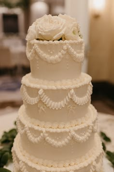 a three tiered wedding cake with white flowers on top