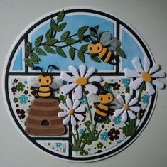 a paper plate with flowers, bees and a beehive