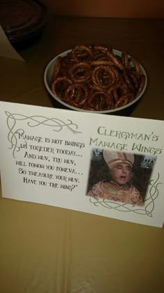 a table topped with a plate of pretzels next to a sign that reads, person's manage dining