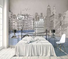 a bed room with a neatly made bed next to a wallpapered cityscape