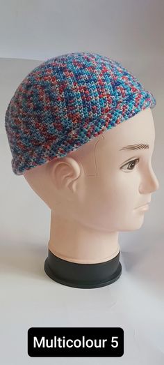 a white mannequin head wearing a multicolored knitted beanie hat