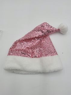 Top off your holiday outfit with this cute Pink Sequin Santa Hat. Featuring small pink sequins on a classic Santa Claus hat and plush white faux fur trim and a matching white pom. Great for a Christmas party, Photo Booth Prop, and more! One size fits most adults and some teens. Pink Sequin hat fits approximately 62 cm or 24 inches and stands from bottom to the top of the pom, fully stretched out, about 18 inches tall. Perfect for Women or Men! This holiday hat is lightweight and comfortable to wear. Spot clean only, Line dry. For ages 14 and older.  🎅Pink and White Sequin Santa Hat. Lightweight and Comfortable to wear! ⭐Great for Women and Men! Break the stereotype this holiday!  🎅Pink Hat fits approximately 62 cm or 24 inches and stands from bottom to the top of the pom 18 inches. ⭐Perf Christmas Party Photo Booth, Pink Santa Hat, Sequin Hat, Sewing Equipment, Gender Fluid, Holiday Hats, Santa Claus Hat, Hat Fits, Holiday Outfit