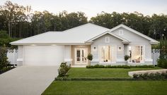 a white house with trees in the background