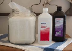 three different types of toiletries sitting on a towel next to a jar of cleaner