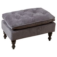 a grey ottoman sitting on top of a wooden frame