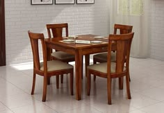 a dining room table and chairs with pictures on the wall behind them in front of a window