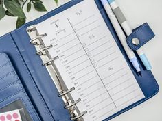 a blue binder and pen on top of a desk