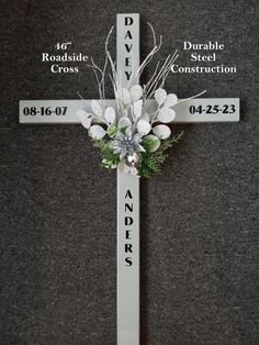 a cross with flowers on it and names in the center, along with arrows pointing to different locations