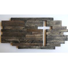 a piece of wood that has been made into a wall hanging on the side of a wall