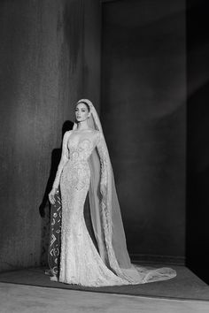 a black and white photo of a woman in a wedding dress with a veil on her head