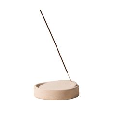 a white object with a wooden stick sticking out of it