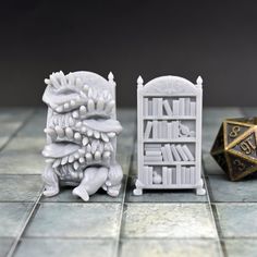 two white bookshelves sitting on top of a tiled floor next to a dice