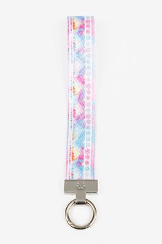 a tie dye keychain with a metal ring on the front and back side