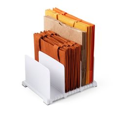 a stack of folders sitting next to each other on a white stand with multiple colors