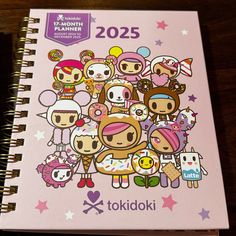 a pink notebook with cartoon characters on it