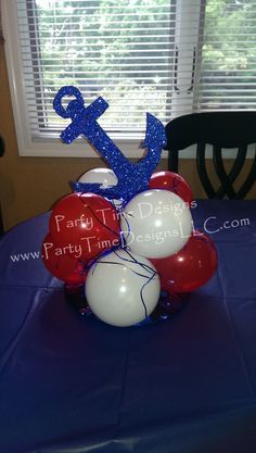 a table with balloons and an anchor on it