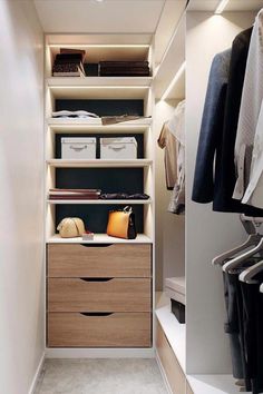 an organized closet with drawers and clothes