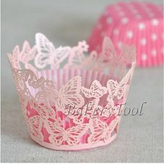 pink cupcake wrappers with white butterflies on them, sitting next to each other