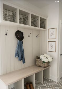 a coat rack with baskets and hats on it