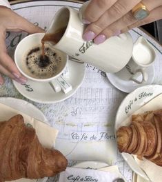 two people are having coffee and croissants