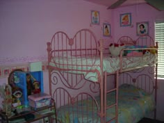 a bedroom with pink walls and bunk beds