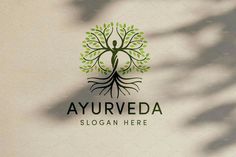 the logo for ayurveda is shown with green leaves and a tree