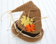 a crocheted hat with an orange and brown design