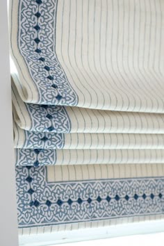 roman blinds with blue and white designs on them