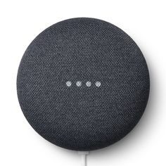 the google home mini speaker is shown on a white surface, with three small dots in front of it