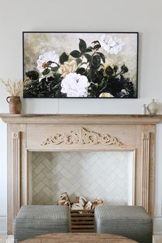 a painting on the wall above a fireplace in a living room