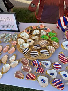 an assortment of decorated cookies and pastries on a table with a sign in the background