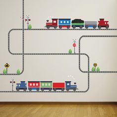 a train wall decal is shown on the wall next to a wooden floor and hardwood floors