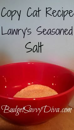 a red bowl filled with food sitting on top of a table next to a sign that says copy cat recipe lawny's seasoned salt