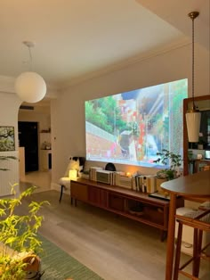 a living room filled with furniture and a flat screen tv mounted to the side of a wall