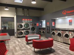 a large laundry room with washers and dryer machines in it's walls