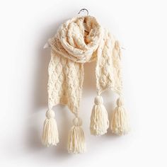 a white scarf with tassels hanging from it