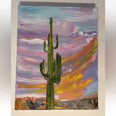 an acrylic painting of a cactus in front of a colorful sky with clouds