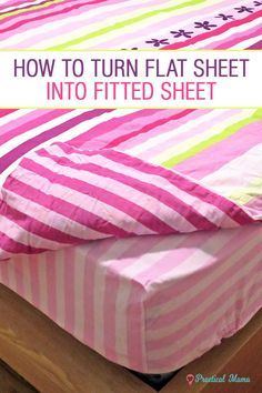 a bed with pink and green striped sheets on it, next to a wooden dresser