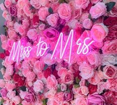 pink flowers with the words miss to mrs written in neon letters on top of them