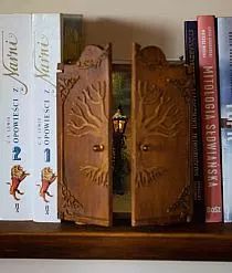 a book shelf with several books on it and an open door to another room in the background