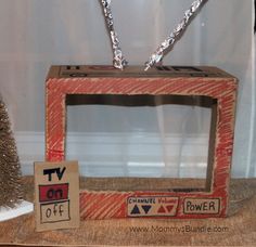 an old tv sitting on top of a table next to a christmas tree and other decorations