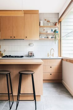 two stools are in front of the kitchen counter