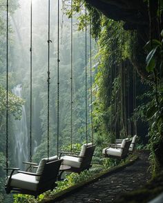 some white chairs hanging in front of a waterfall