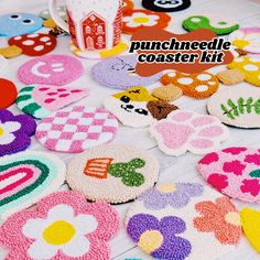 a table topped with lots of decorated cookies next to a cup filled with coffee mug