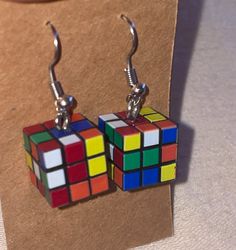 Mini rubix cube-inspired earrings. A one-of-kind gift for the classic puzzle lover! Retro Hypoallergenic Earrings For Gift, Square Hypoallergenic Earrings For Gift, Hypoallergenic Square Earrings For Gifting, Hypoallergenic Square Earrings As Gift, Hypoallergenic Square Earrings For Gifts, Multicolor Square Jewelry Gift, Multicolor Square Jewelry For Gifts, Retro Rectangular Earrings For Gift, Multicolor Rectangular Earrings As A Gift