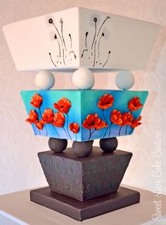 a blue and white vase with orange flowers on it