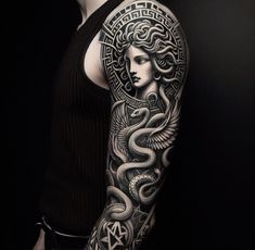 a woman's arm with an intricate tattoo design on the arm and shoulder,