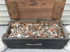 an old trunk filled with coins and pins