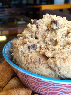 a bowl filled with food next to crackers